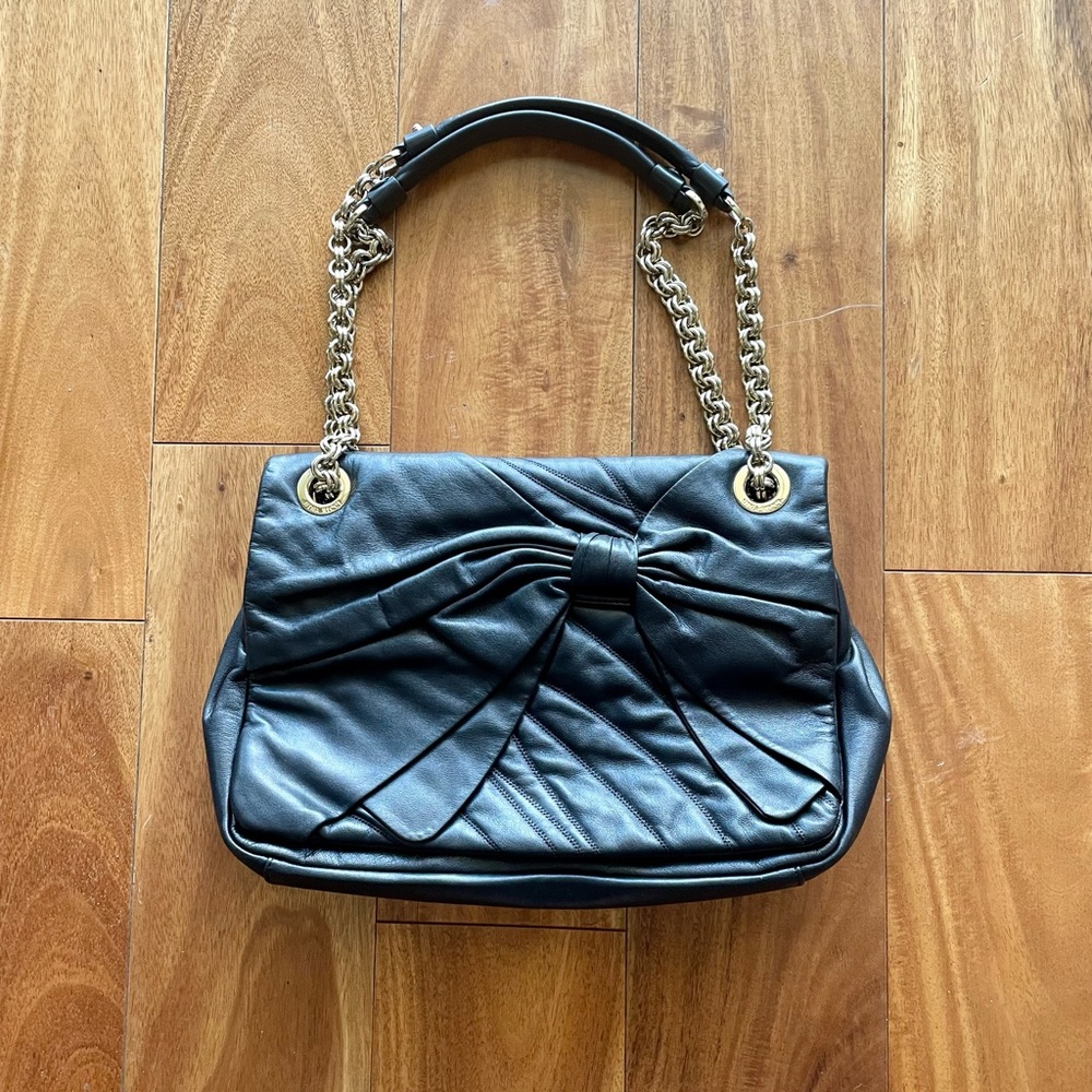Black leather handbag by Nina Ricci